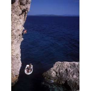  Male Rock Climbing on the Coast of Hvar, Croatia Stretched 