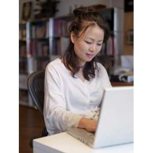  Close up View of a Young Asian Woman Typing on a Laptop 
