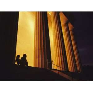  Two Girls in Silhouette Sit on the Steps of the Lincoln 