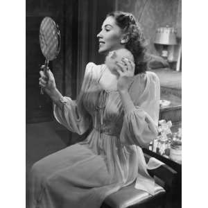  Woman Applying Face Powder, Looking at Hand Mirror 