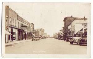Cheboygan, MI Michigan old RPPC Postcard Street Scene Pontiac Dealer 