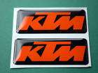 DOMED KTM STICKERS ORANGE ON BLACK 60mm x 25mm