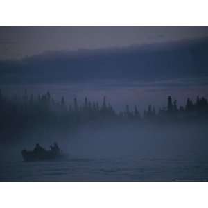  Fishermen Cast from Their Boat That is Surrounded in Mist 